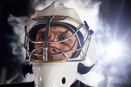 Close-Up Shot of Man Wearing a Hockey Helmet