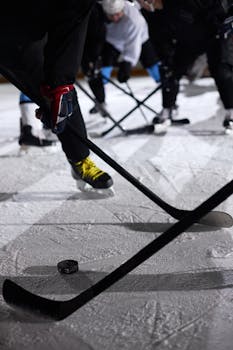 Exciting close-up of a hockey game on an indoor rink featuring players in action.