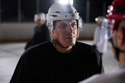 Free Close-up of an ice hockey player focused and serious during a practice session on the rink. Stock Photo