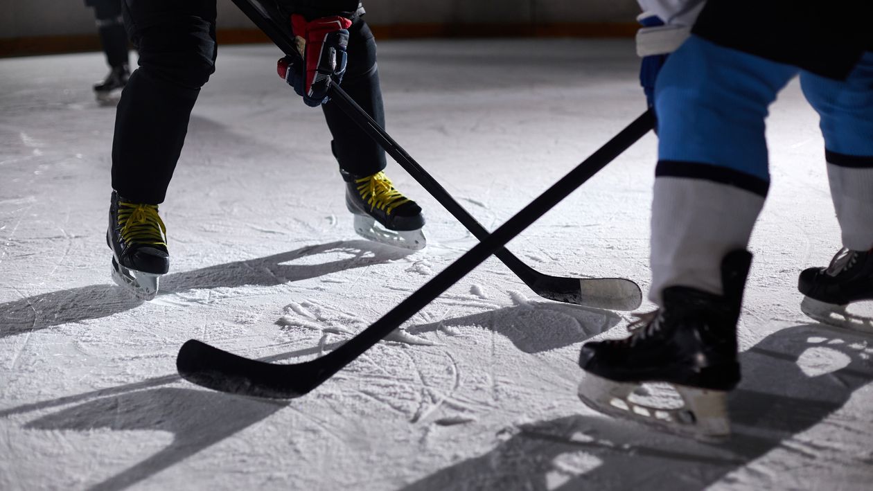 Hockey players battling for the puck during a face-off