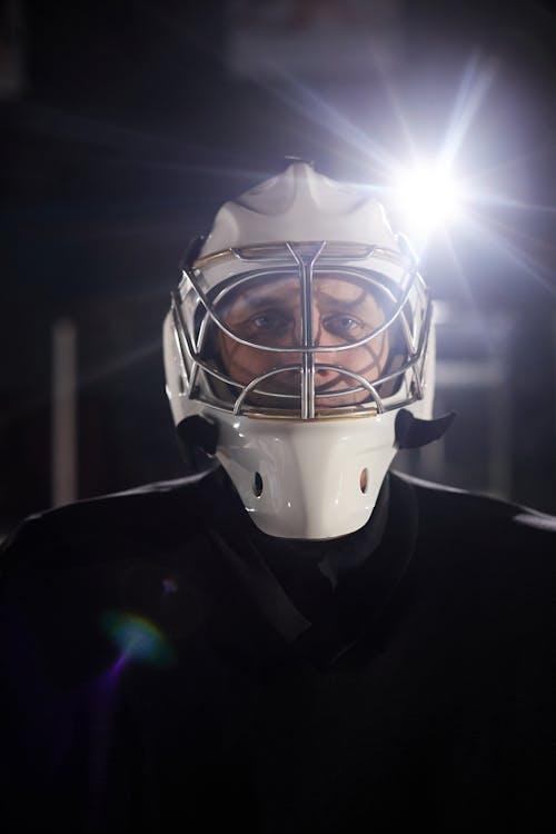 Man in Black Top Wearing White Helmet