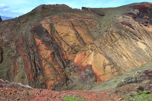 Free Explore the striking colors and textures of a rugged mountain landscape under a clear sky. Stock Photo