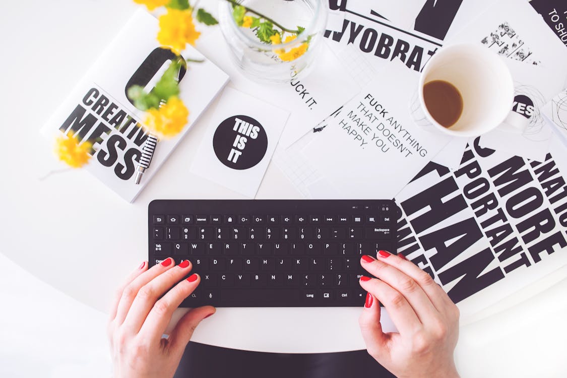 Girl writing on a black keyboard 