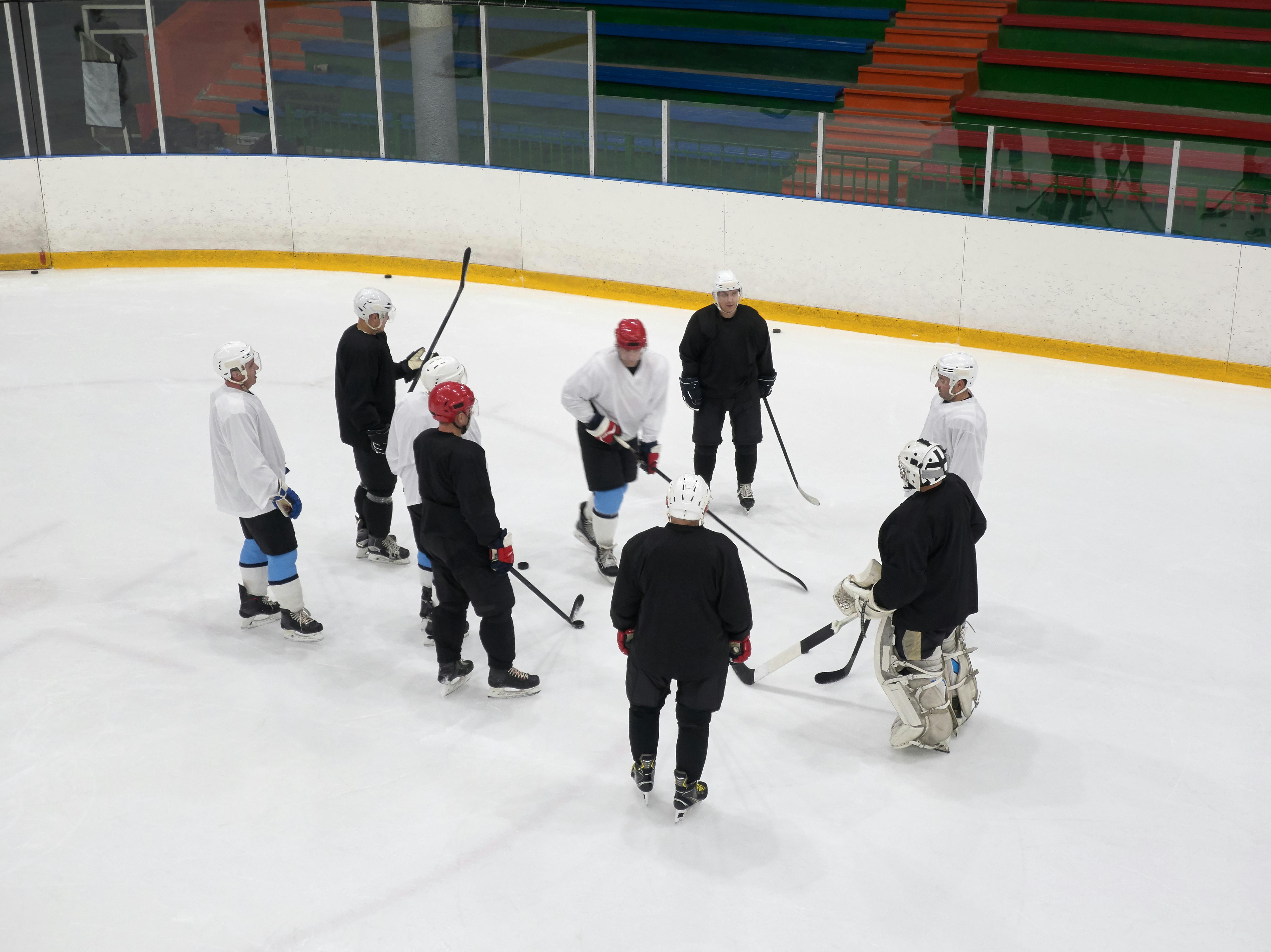 high angle shot of men playing ice hockey