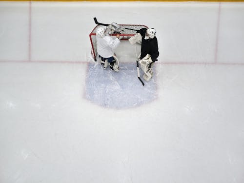 Two Men Playing Ice Hockey