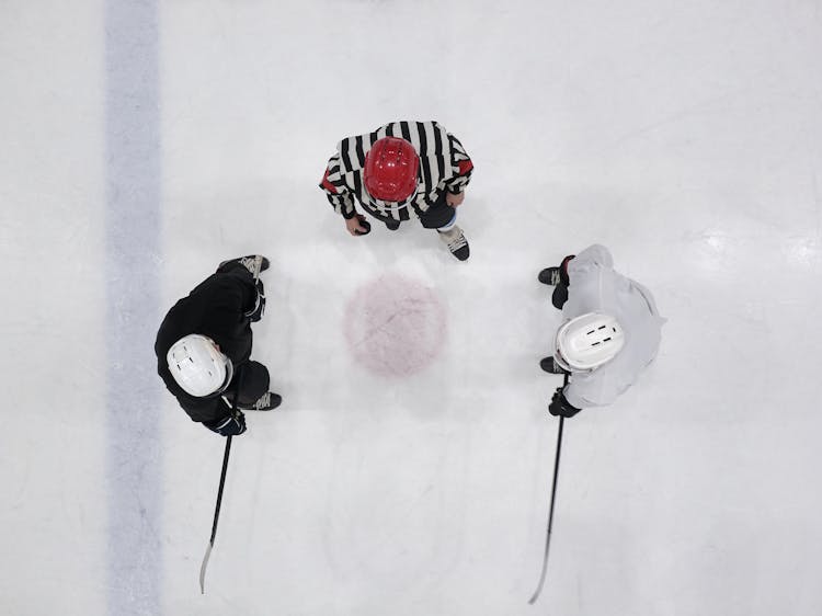 Top View Of Men Playing Ice Hockey