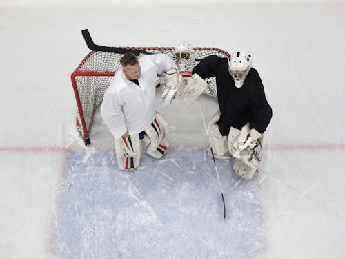 High-Angle Shot of Two Goaltenders Standing near the Goal