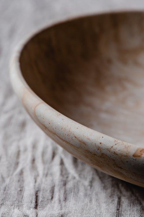 Brown Round Bowl on White Textile