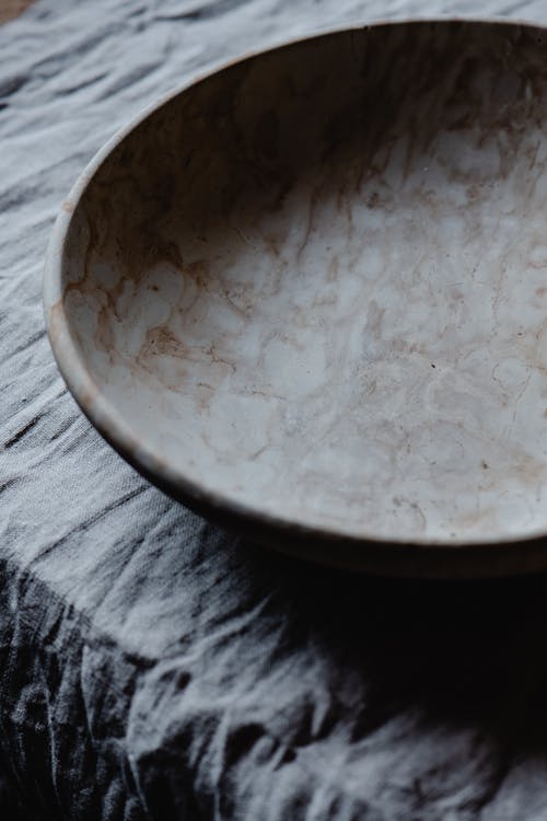 Free Ceramic Plate on Gray Textile Stock Photo