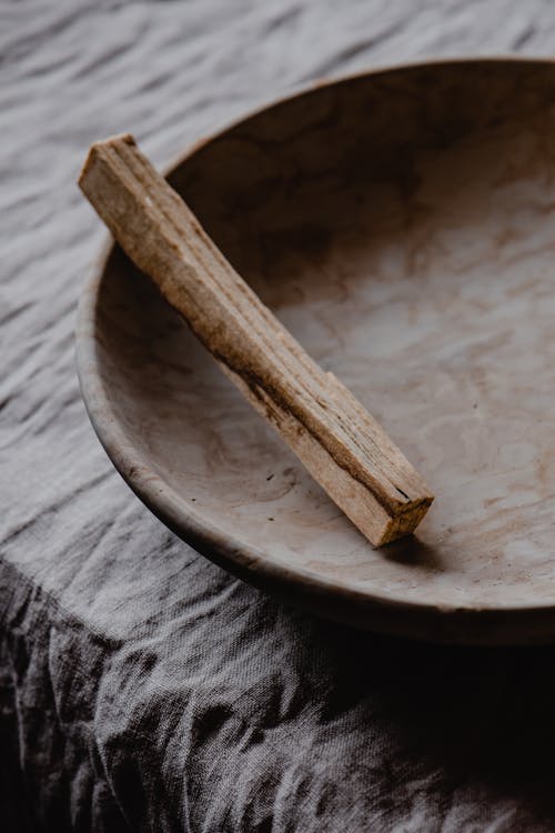 Brown Wooden Stick on Round Brown Plate