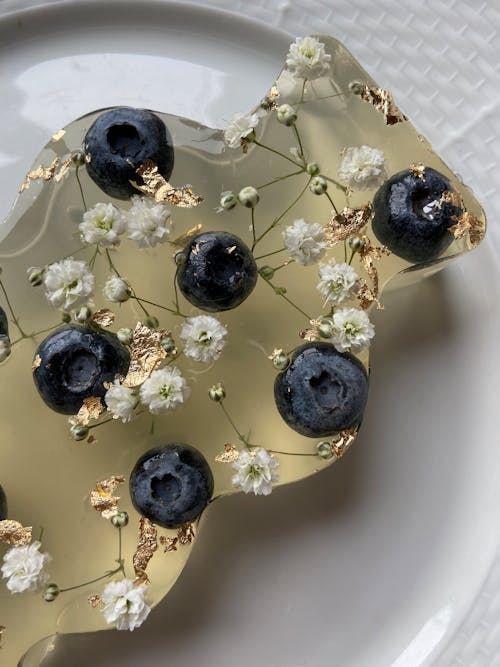 Sweet jelly desert with blueberries and flowers