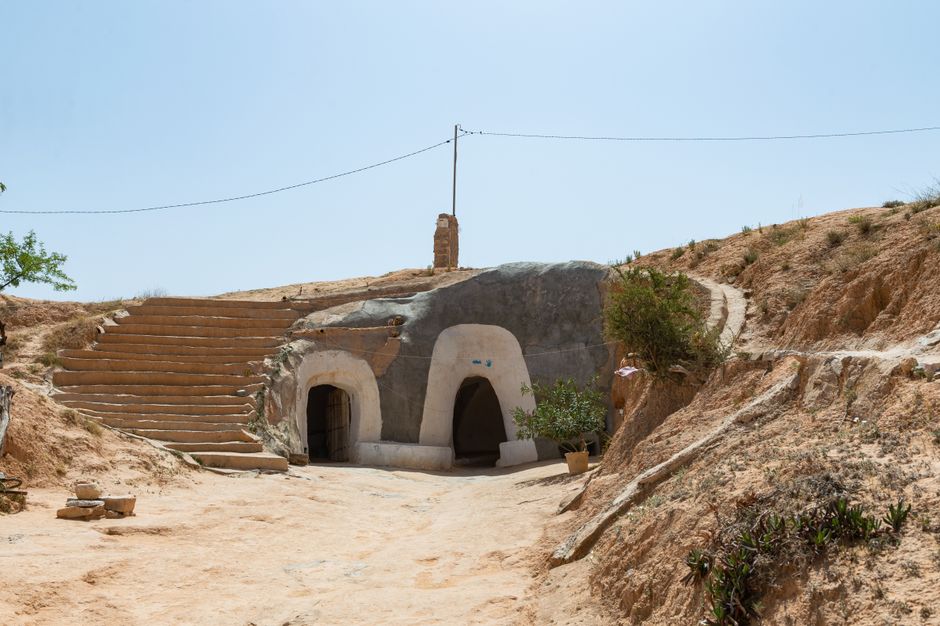 Discover ancient Berber cave homes carved into the desert landscape of Matmata, Tunisia.