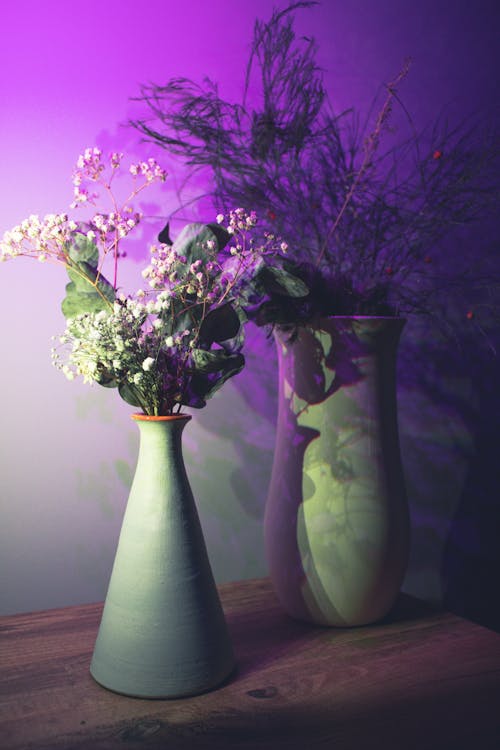 Purple and White Flowers in Green Ceramic Vase