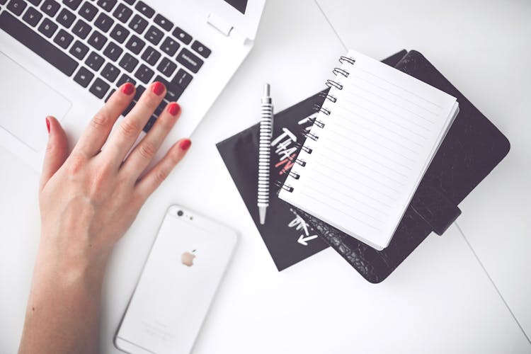 White Laptop, Female Hand, Note, Pen, Phone, Desk