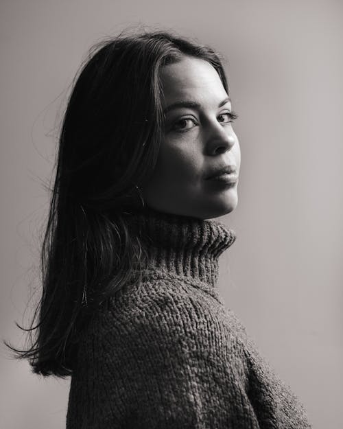 woman in Turtleneck Sweater Looking Over Her shoulder