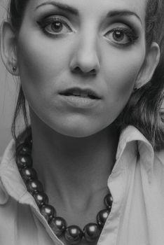 Stunning black and white portrait of a woman in a studio, featuring elegant jewelry.