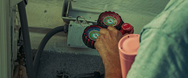 HVAC technician using field service management app to schedule heating and cooling repair jobs