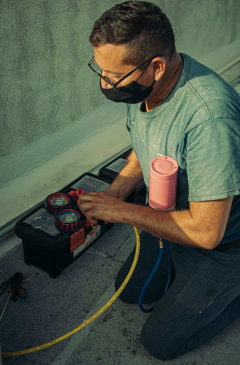 HVAC technician performing maintenance
