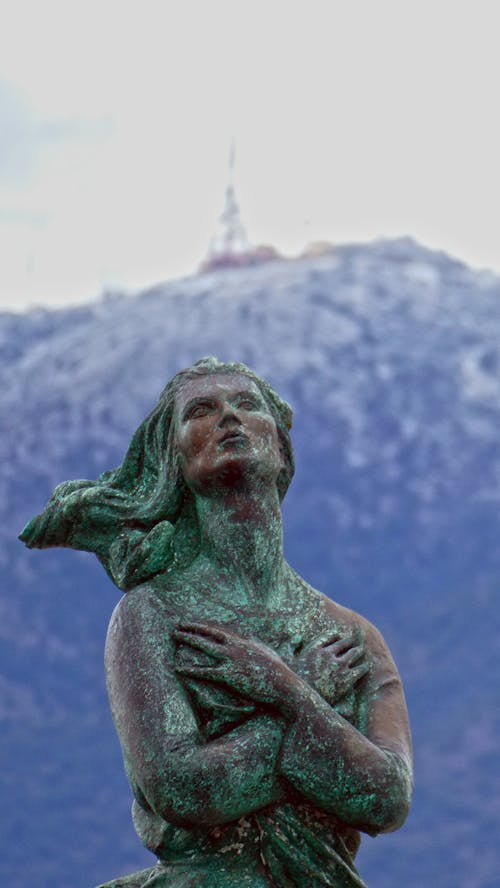 Statue of a Woman with Hands on Chest