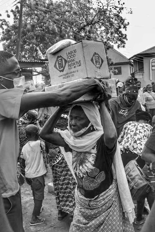 Free Grayscale Photo of People Getting Food Relief Stock Photo