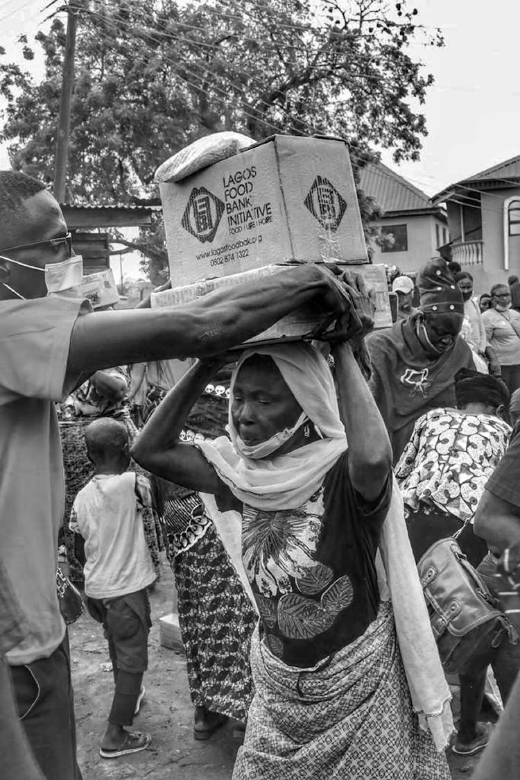 Grayscale Photo Of People Getting Food Relief