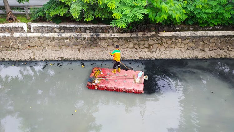 Drone Shot Of A Man Cleaning A River