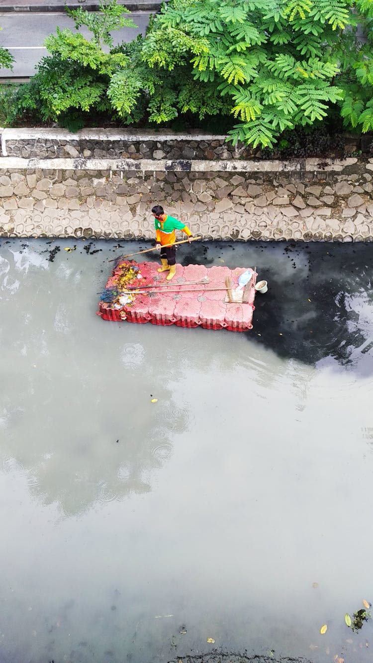 Drone Shot Of A Man Cleaning A River