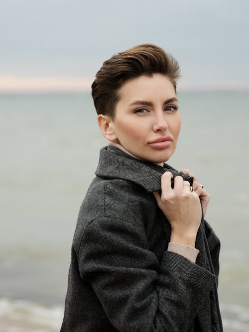Woman Wearing Gray Coat Holding Her Collar
