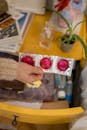 Person Holding Three Pink Condoms