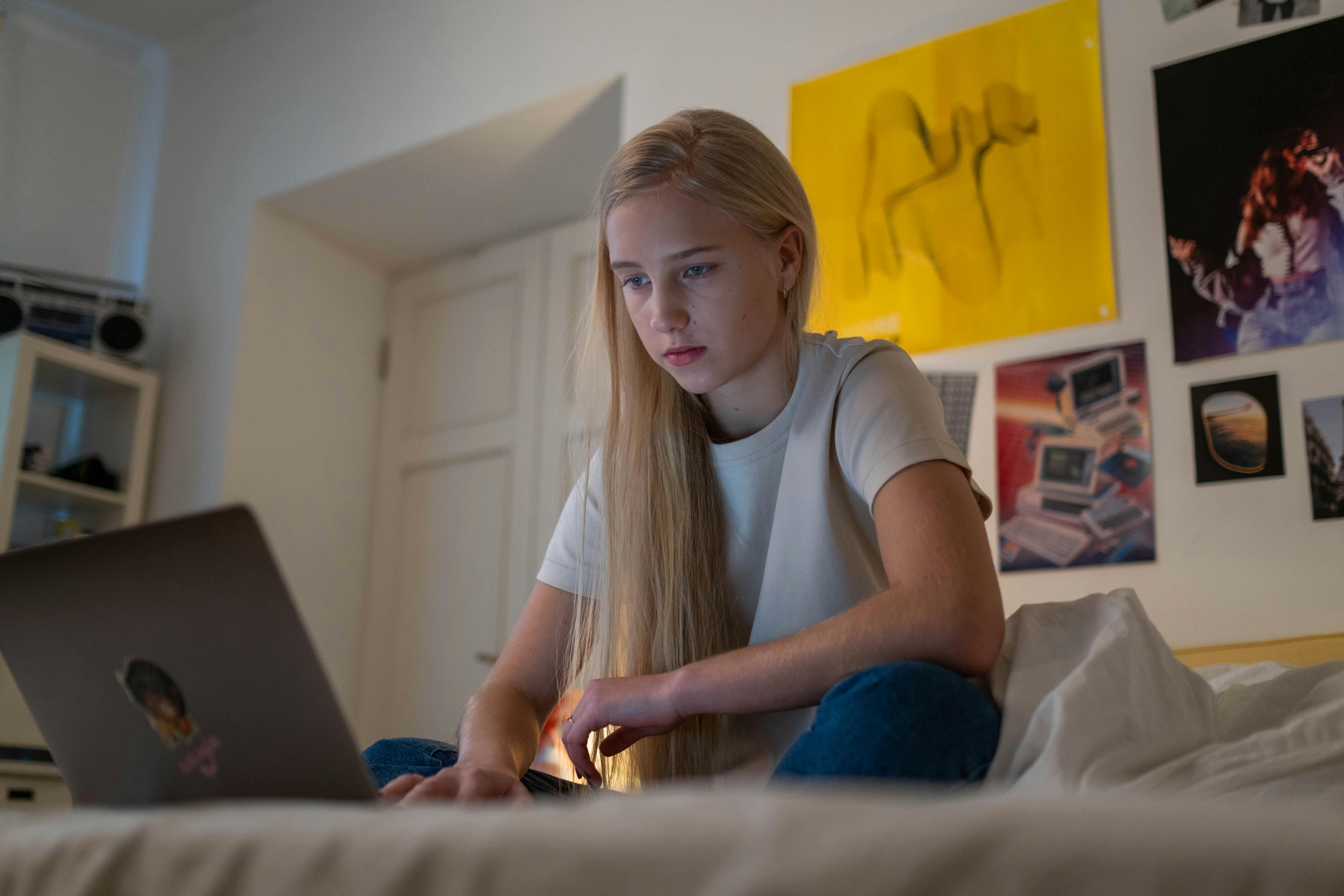 teenager browsing on her laptop