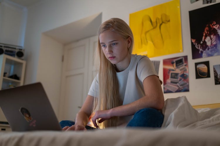 Teenager Browsing On Her Laptop