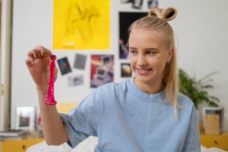 Teenager Holding A Condom