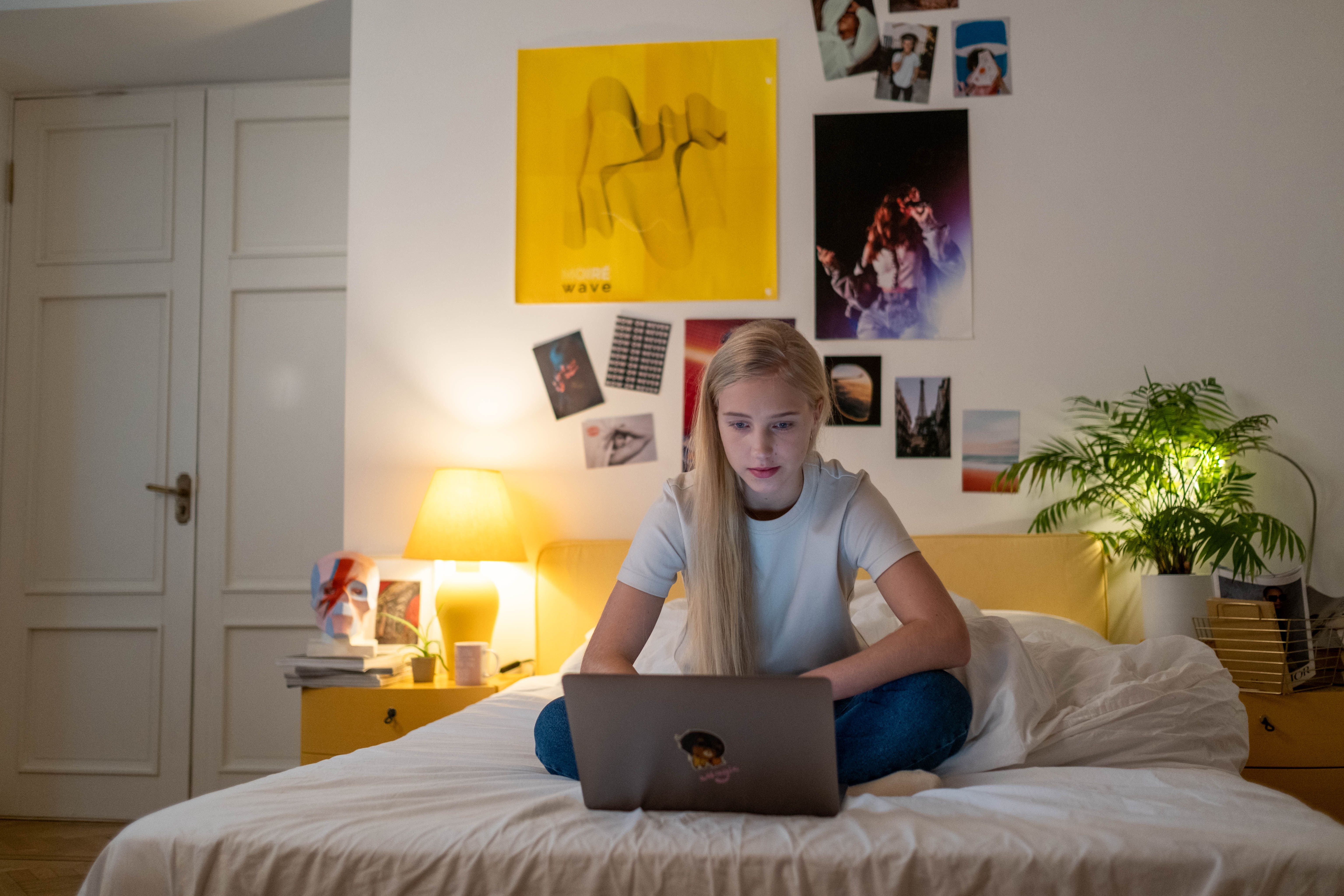A person in bed looking at her laptop