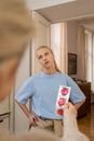 A Person Holding Condoms In Front of a Young Woman