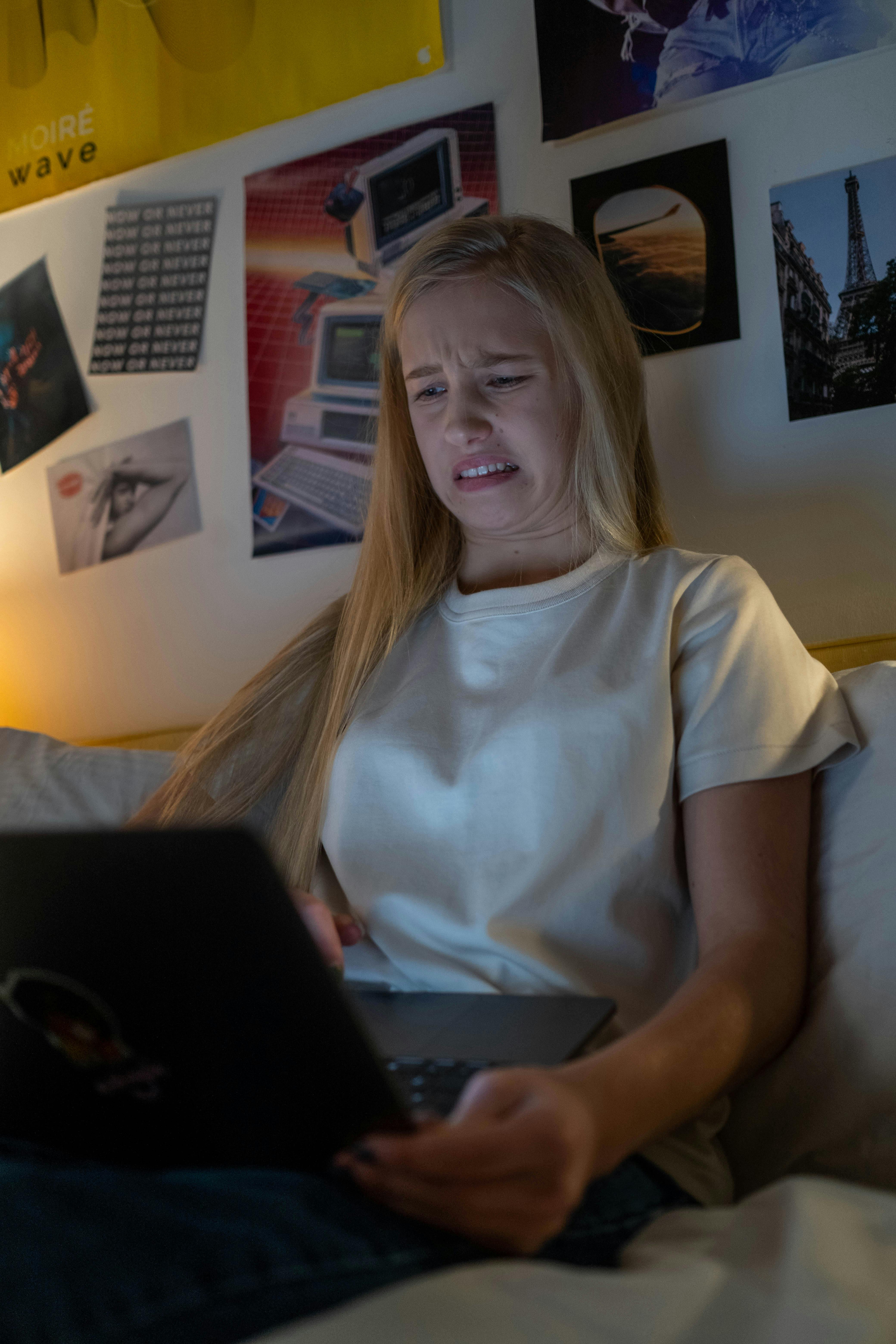 female teenager looking disgusted while watching