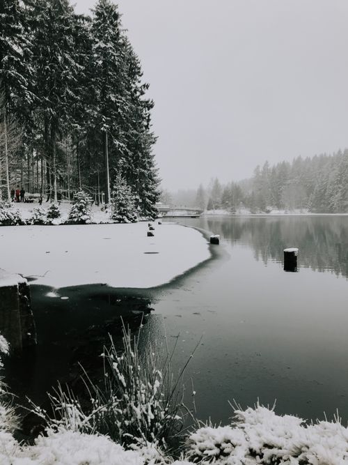 Free Peaceful snow-covered landscape of Fichtelberg Lake during winter. Stock Photo