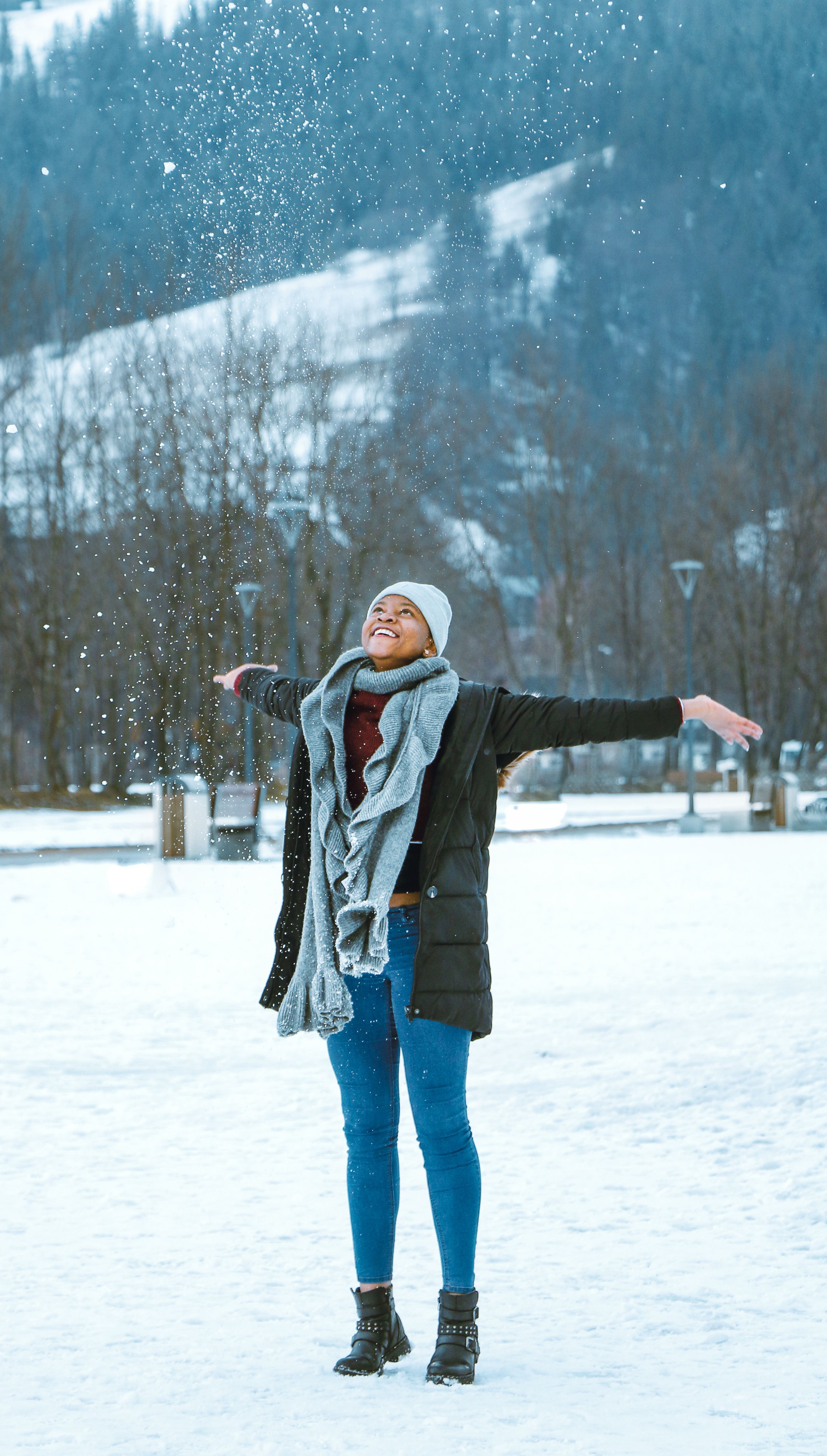 Woman in jeans with beanie and parka in winter