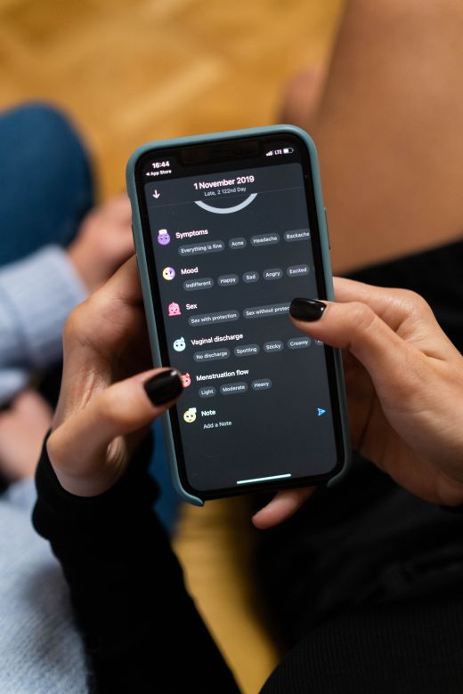 Person using a health-tracking app on a phone — photo by cottonbro studio on Pexels