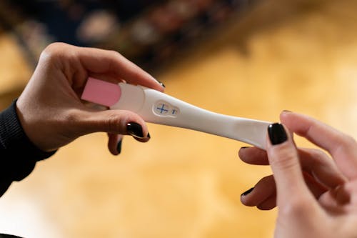 Hands Holding Pregnancy Test Kit early signs of pregnancy