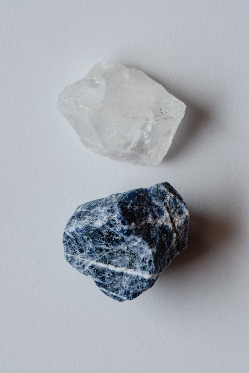 Free A White and Blue Gem Stones on White Surface Stock Photo