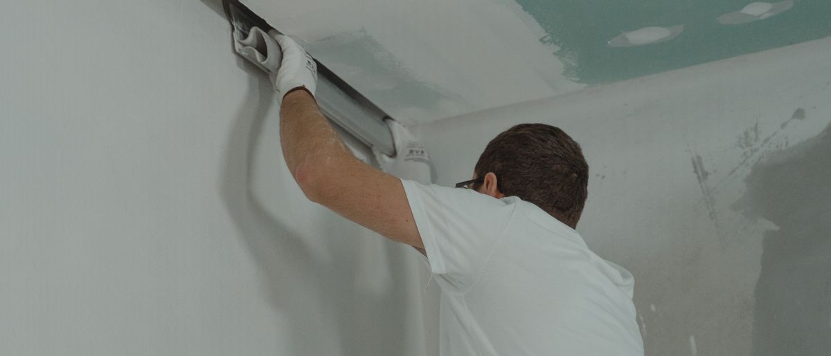 Worker installing and finishing drywall in a DMV home