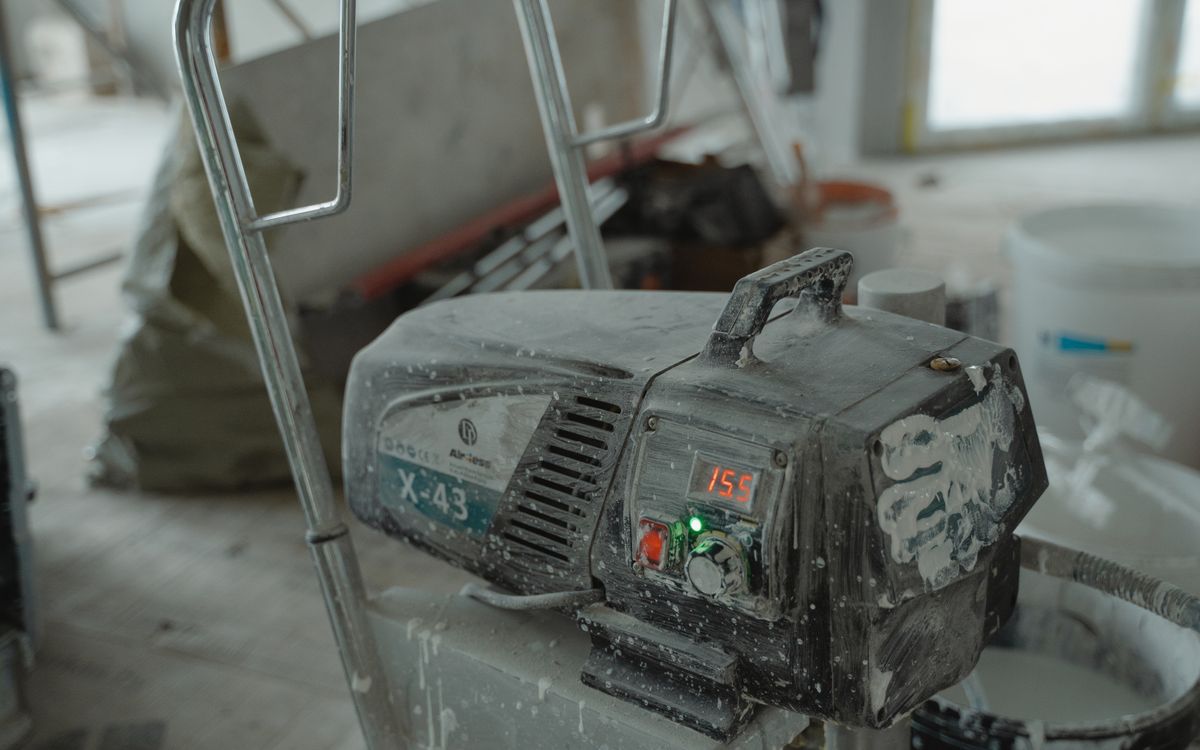 Close-up of industrial construction equipment at a renovation site, emphasizing machinery details.