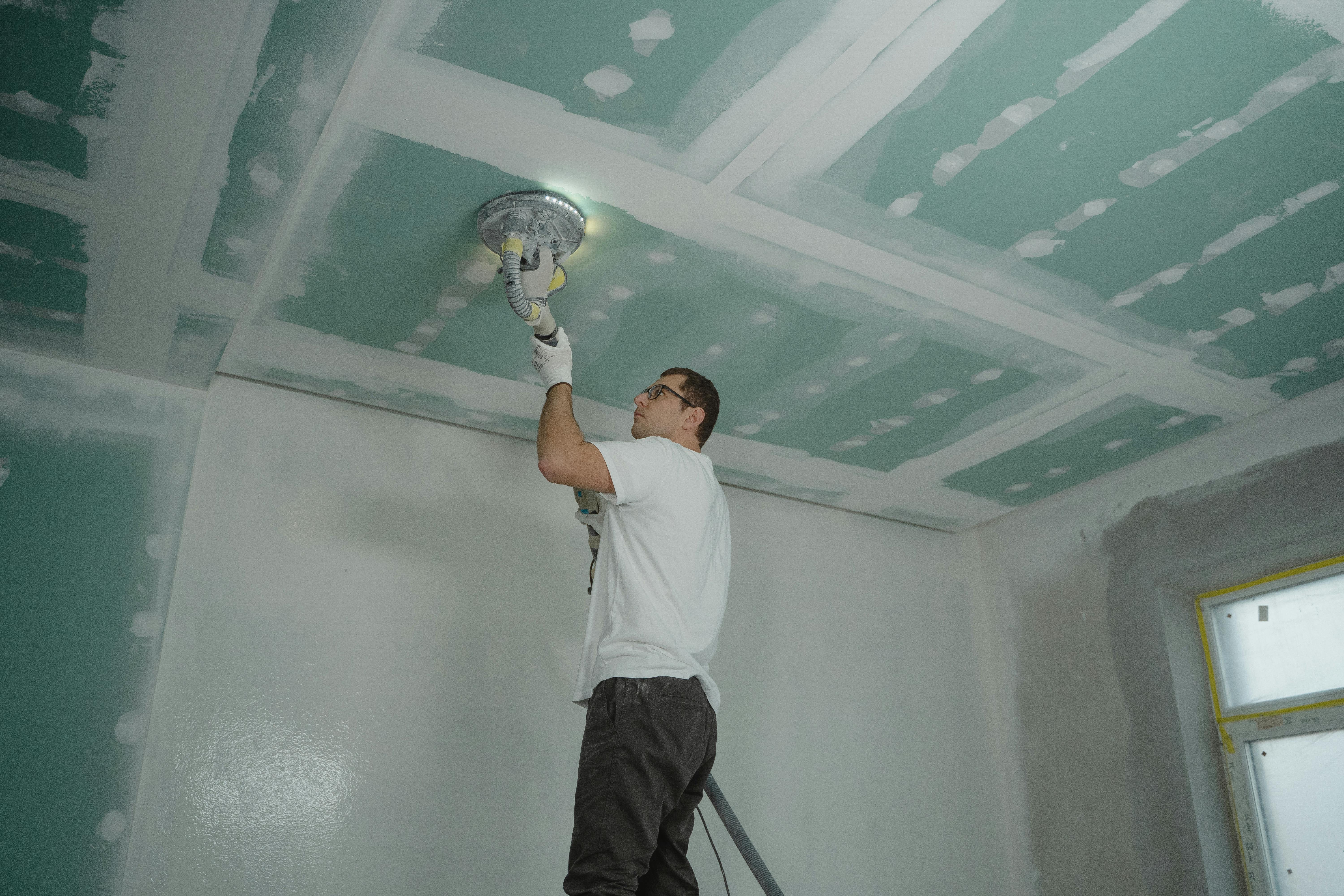 Free Man Polishing the Ceiling Stock Photo