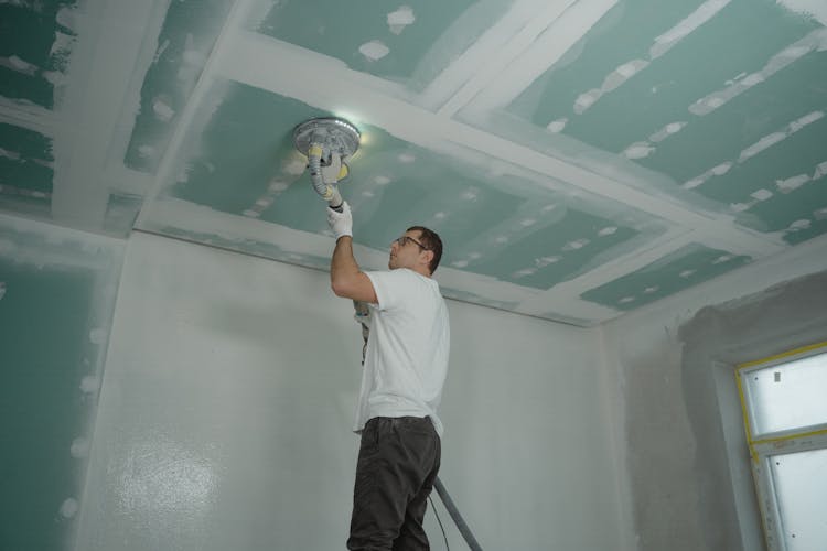 Man Polishing The Ceiling