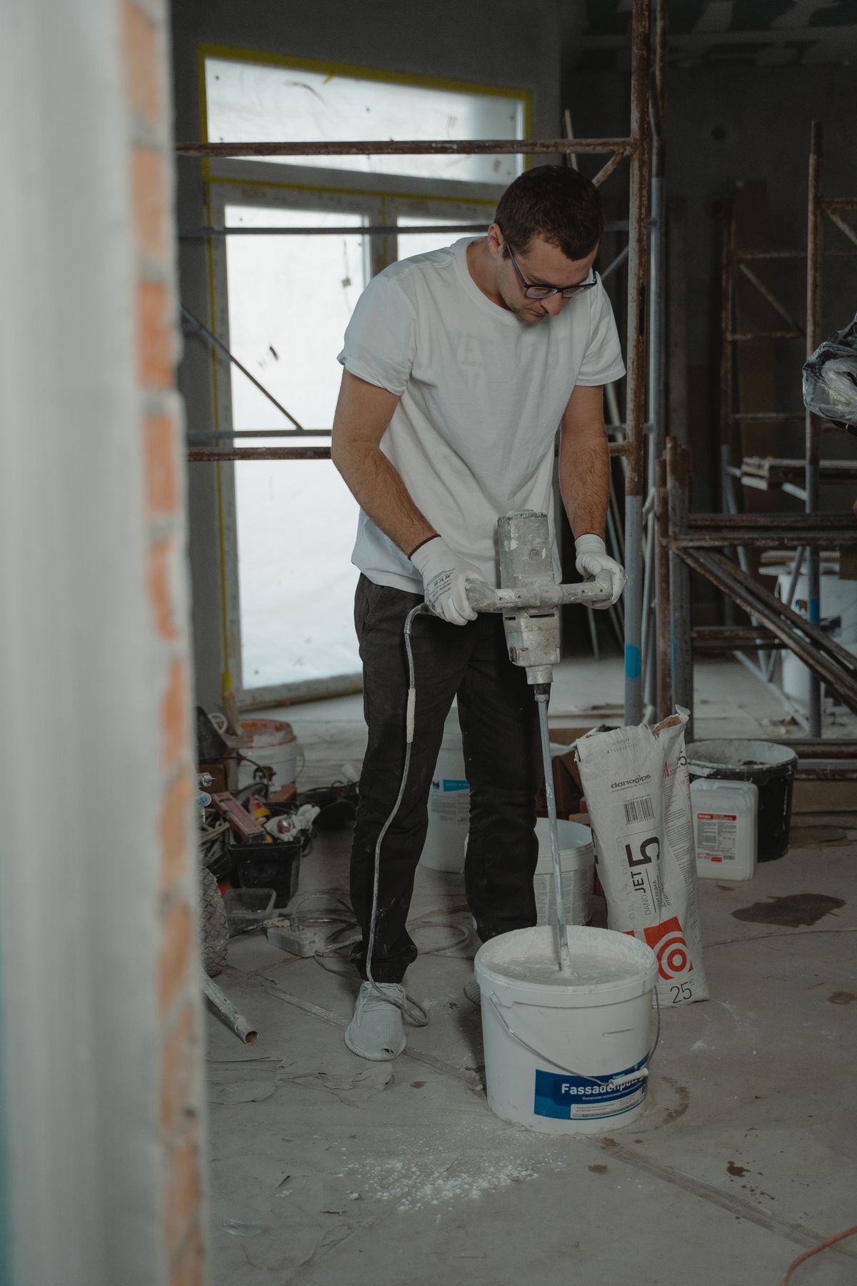 Professional painter mixing coating material before application
