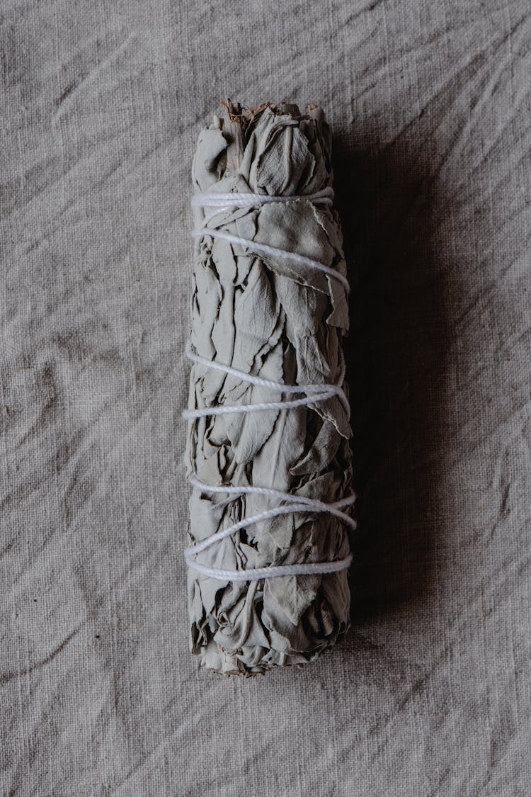 A Bundle Of White Sage On Gray Textile