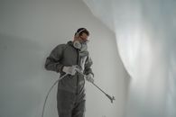 Man in Black Jacket and Pants Holding Black and White Stick
