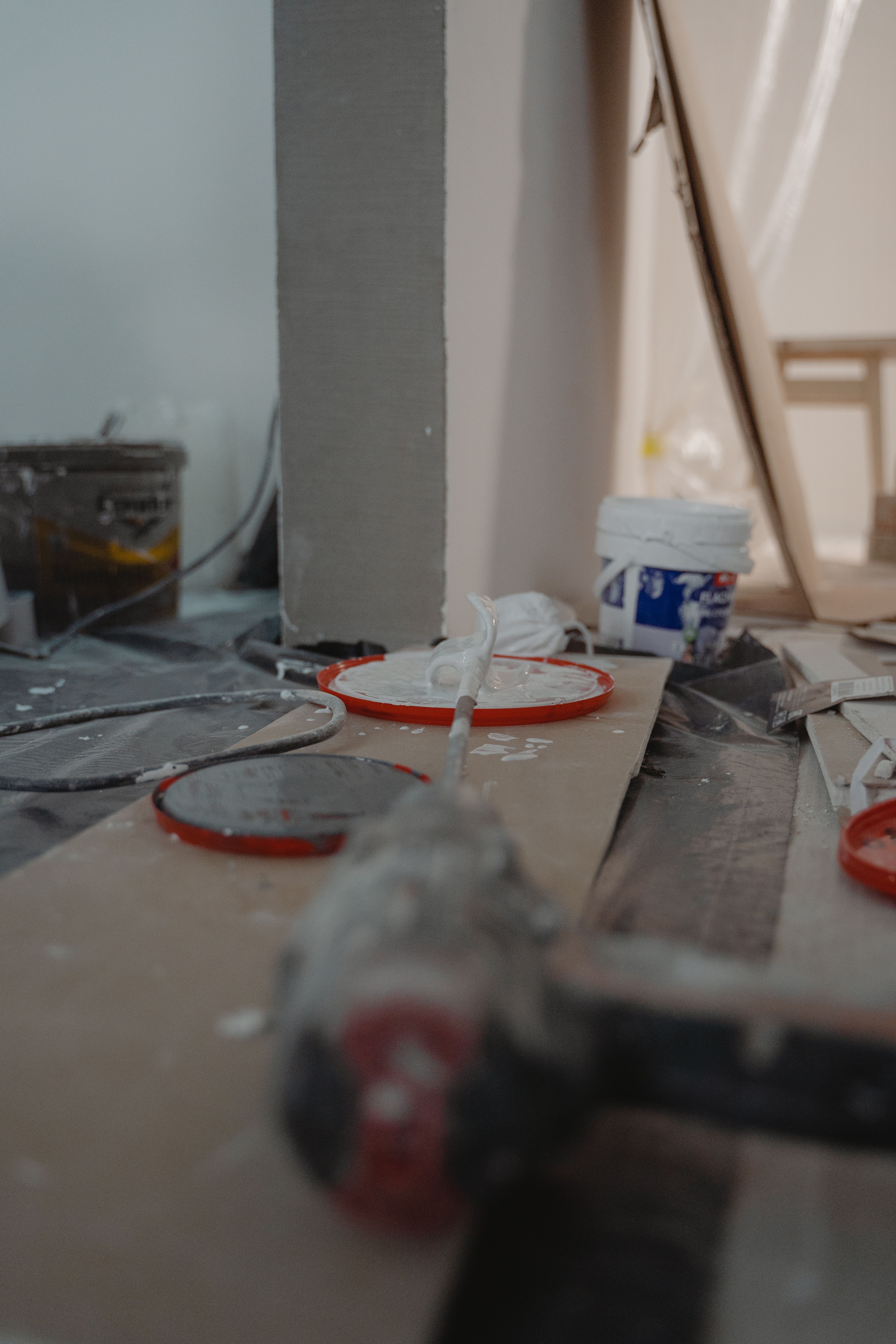 Professional tools and building materials arranged on the floor during a home renovation.