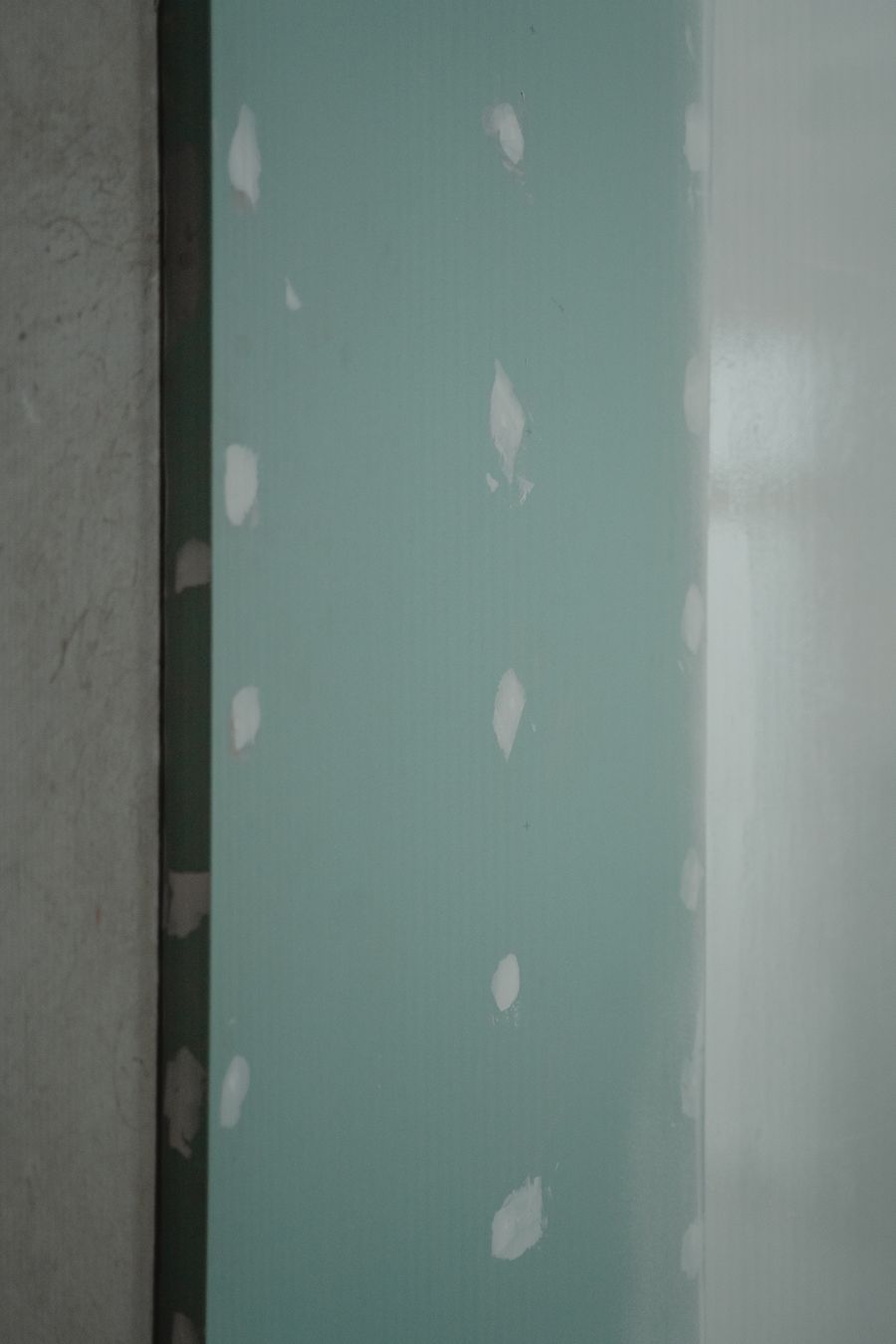 Interior wall repair with fresh drywall patches ready for finishing.