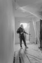 Man in Black Jacket and Pants Standing on White Floor